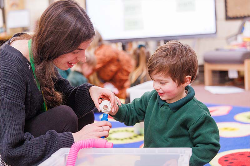 teacher and student playing with blocks